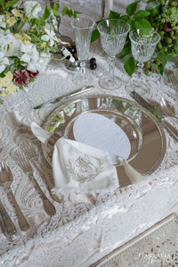3D Sculped Menu with Letter press Elegant table setting with white flowers, silverware, and a monogrammed napkin.
