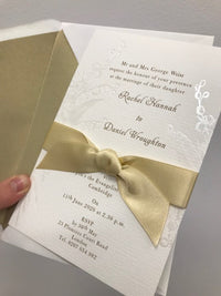 Elegante invito con mughetto in rilievo con perle, nastro francese in raso e inchiostro dorato